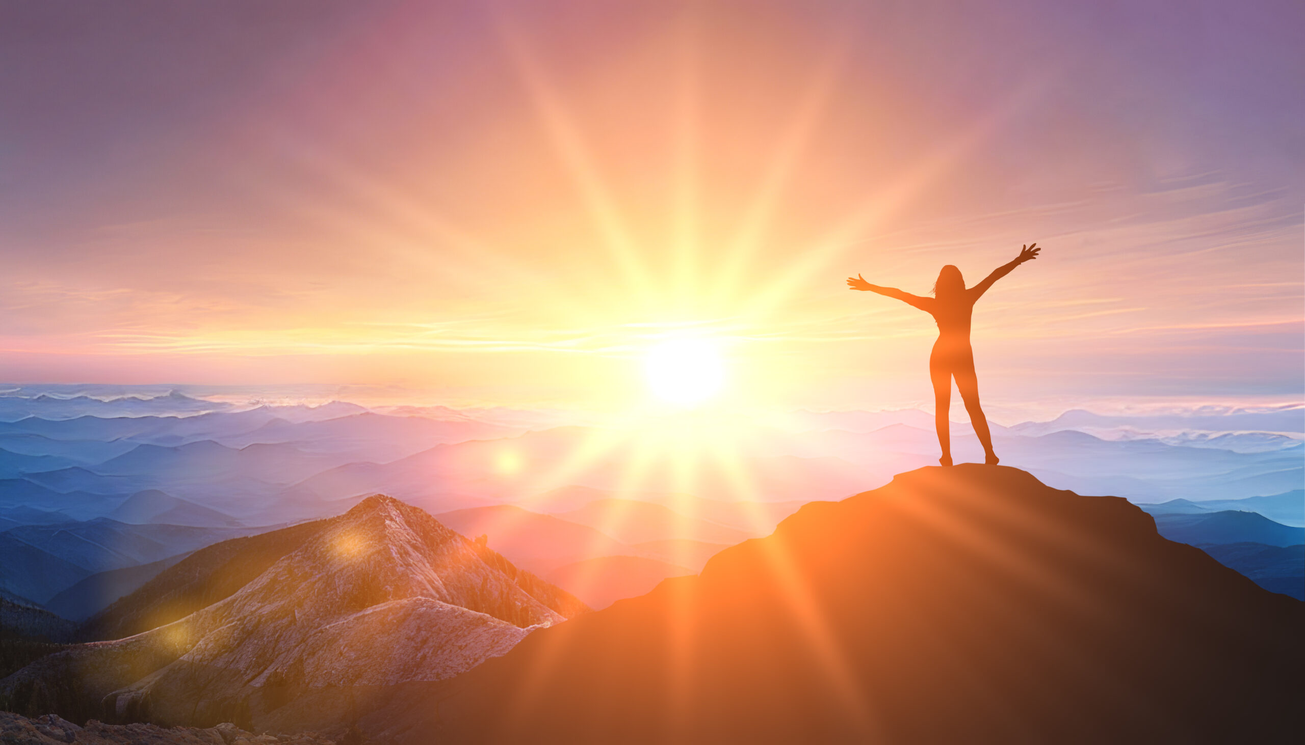 Woman Standing At Top Of Mountain As Sun Begins To Set. Success Business Leadership. Goals, Hopes And Aspirations Concept. Female Silhouette On Sunrise Mountain Background